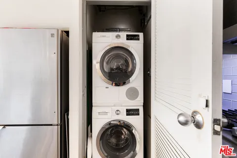 a view of storage and utility room with washer and dryer