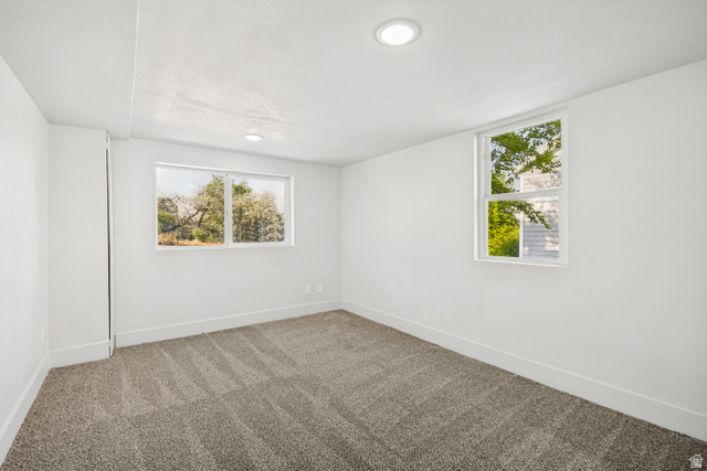 662 29th Street Ogden, UT 84403 - Photo 18 of 23 Spacious room featuring neutral carpeting, recessed ceiling lighting, and two windows providing natural light