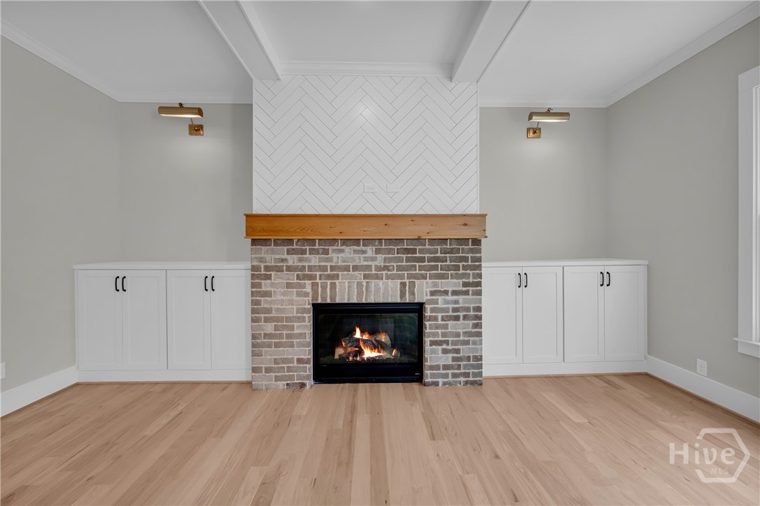 2476 St Martin Way Monroe, GA 30656 - Photo 10 of 75 Fireplace featuring a brick surround, wood mantel, and herringbone tile accent