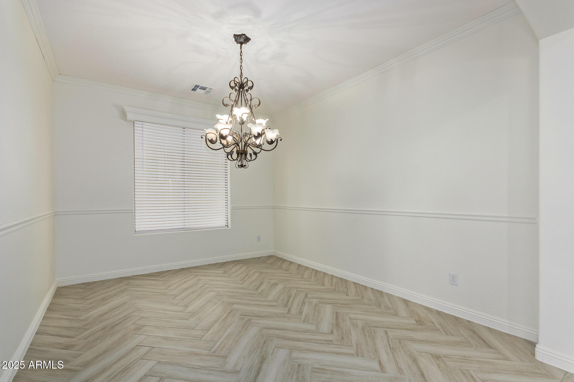 13635 West Calavar Road Surprise, AZ 85379 - Photo 19 of 76 a view of a room with a chandelier fan and windows