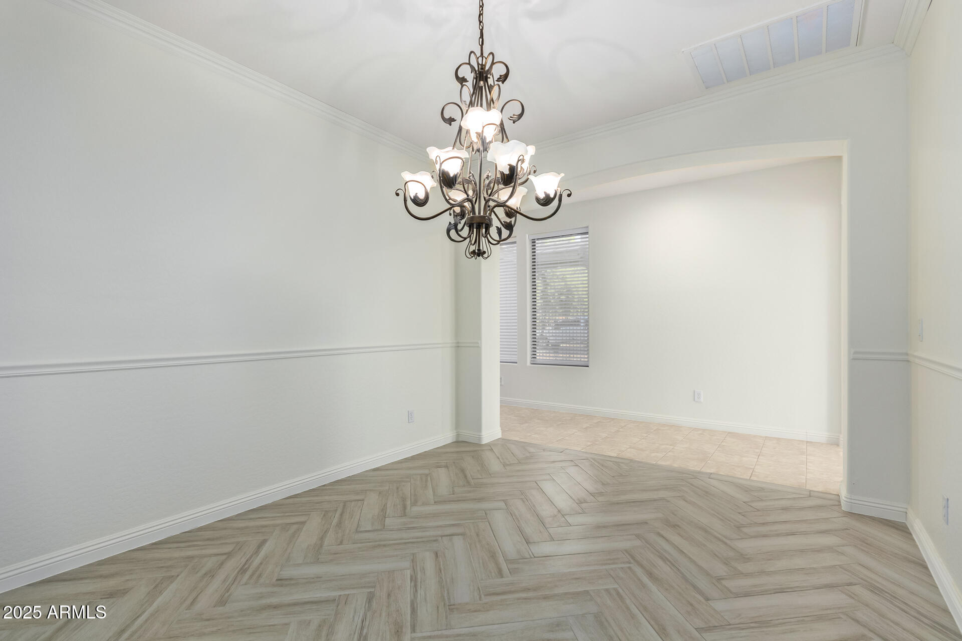 13635 West Calavar Road Surprise, AZ 85379 - Photo 21 of 76 a view of a chandelier in an empty room