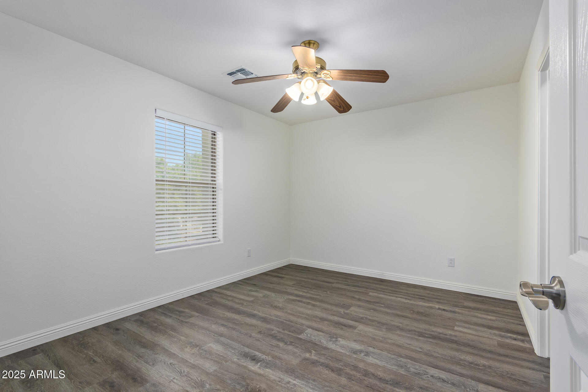 13635 West Calavar Road Surprise, AZ 85379 - Photo 57 of 76 wooden floor in an empty room with a window