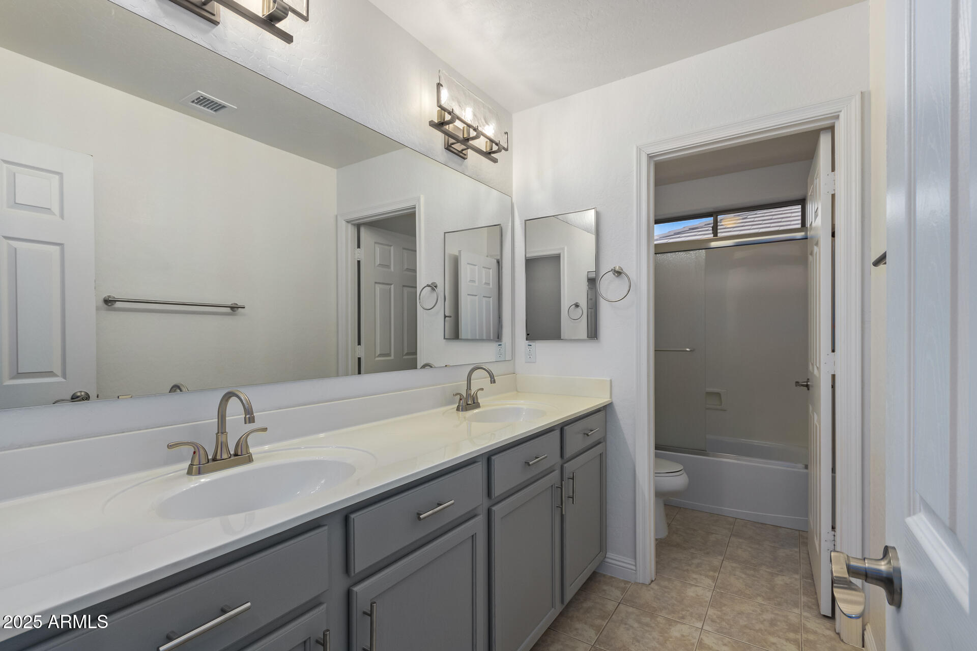13635 West Calavar Road Surprise, AZ 85379 - Photo 63 of 76 a bathroom with a sink double vanity granite tub and shower