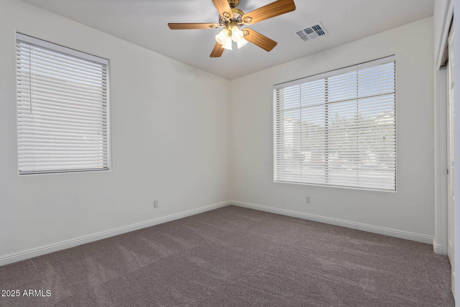 13635 West Calavar Road Surprise, AZ 85379 - Photo 64 of 76 an empty room with a window and a fan