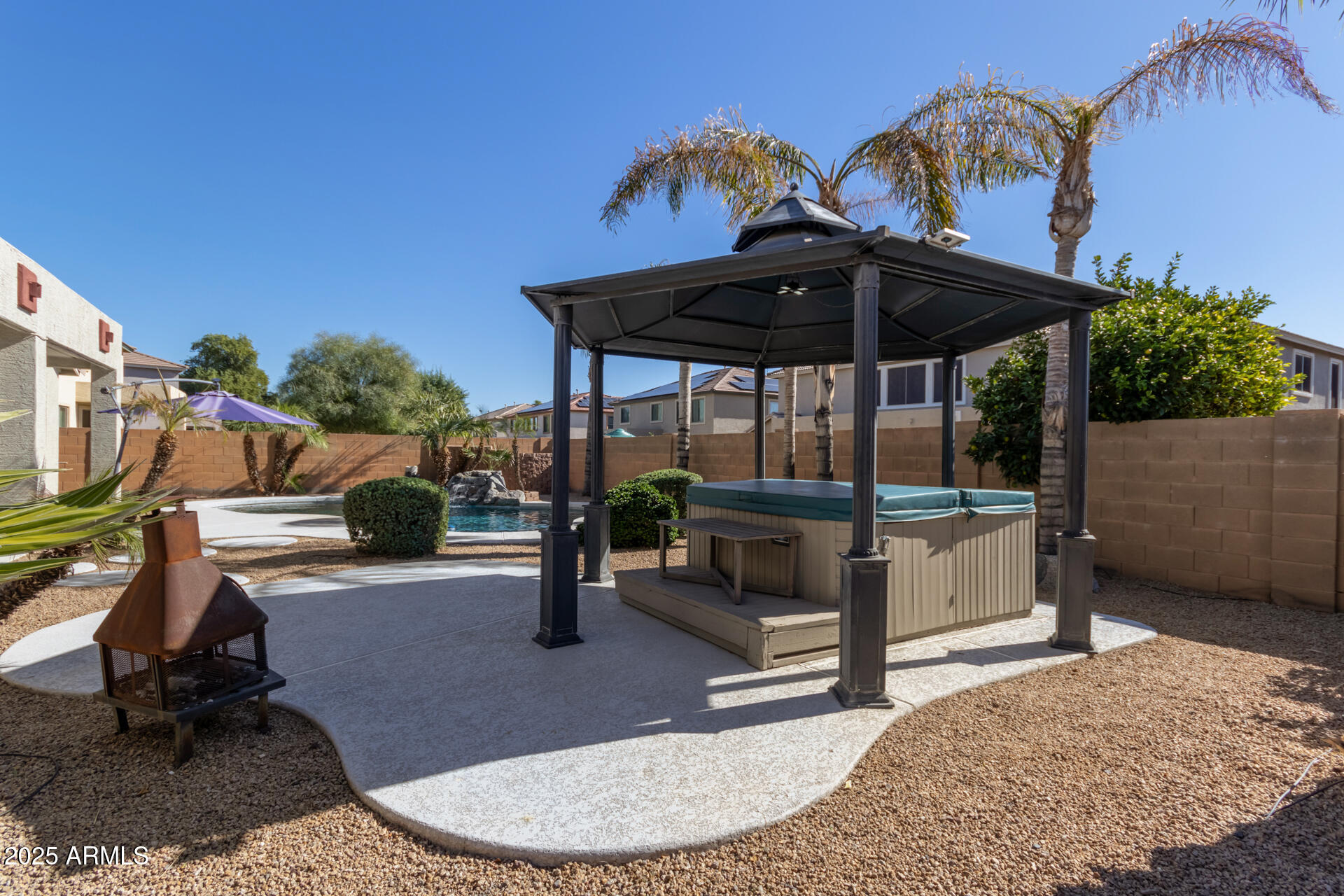 13635 West Calavar Road Surprise, AZ 85379 - Photo 74 of 76 a backyard of a house with barbeque oven table and chairs