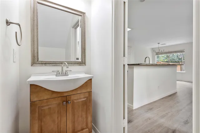 a bathroom with a sink a mirror and a vanity