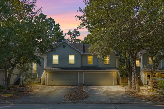 a view of house with a tree in front of it
