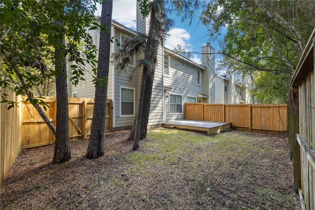 a backyard of a house with a tree