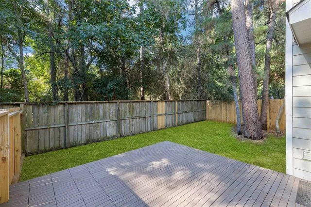 a view of a backyard with wooden fence