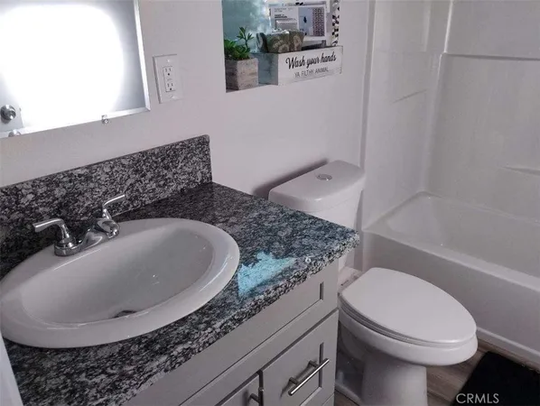 a bathroom with a toilet a sink and bathtub