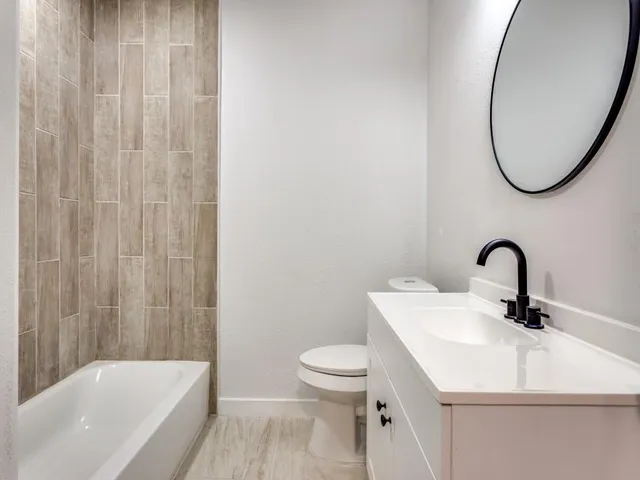 a bathroom with a sink a toilet and a bathtub
