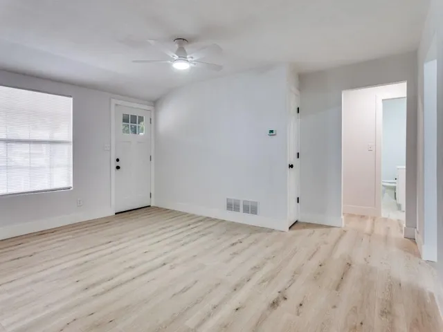 wooden floor in an empty room with a window