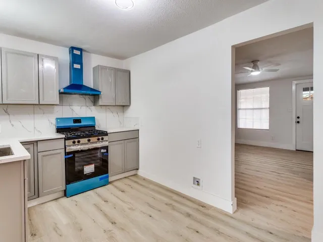a kitchen with stainless steel appliances granite countertop a stove and a refrigerator
