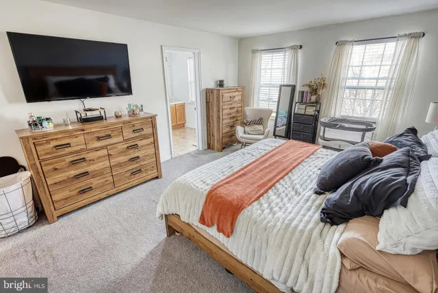 a bedroom with a bed and flat screen tv