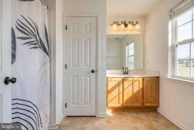 a view of a bathroom with a bathtub and shower