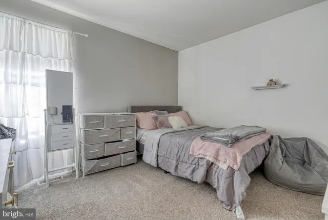 a bedroom with a bed and a cabinets