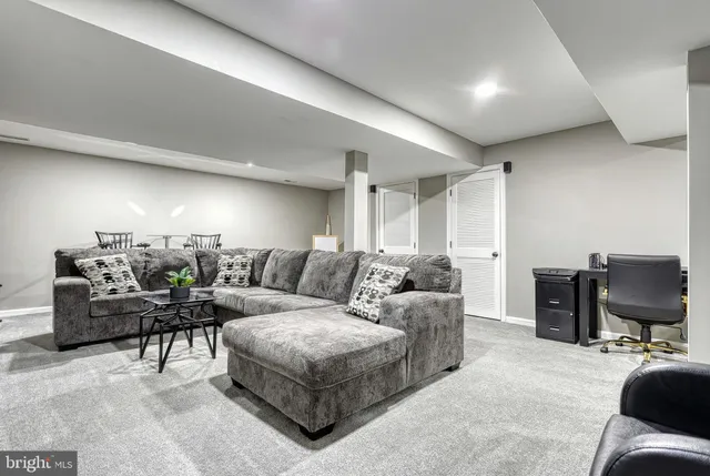 a living room with furniture a desk and chair