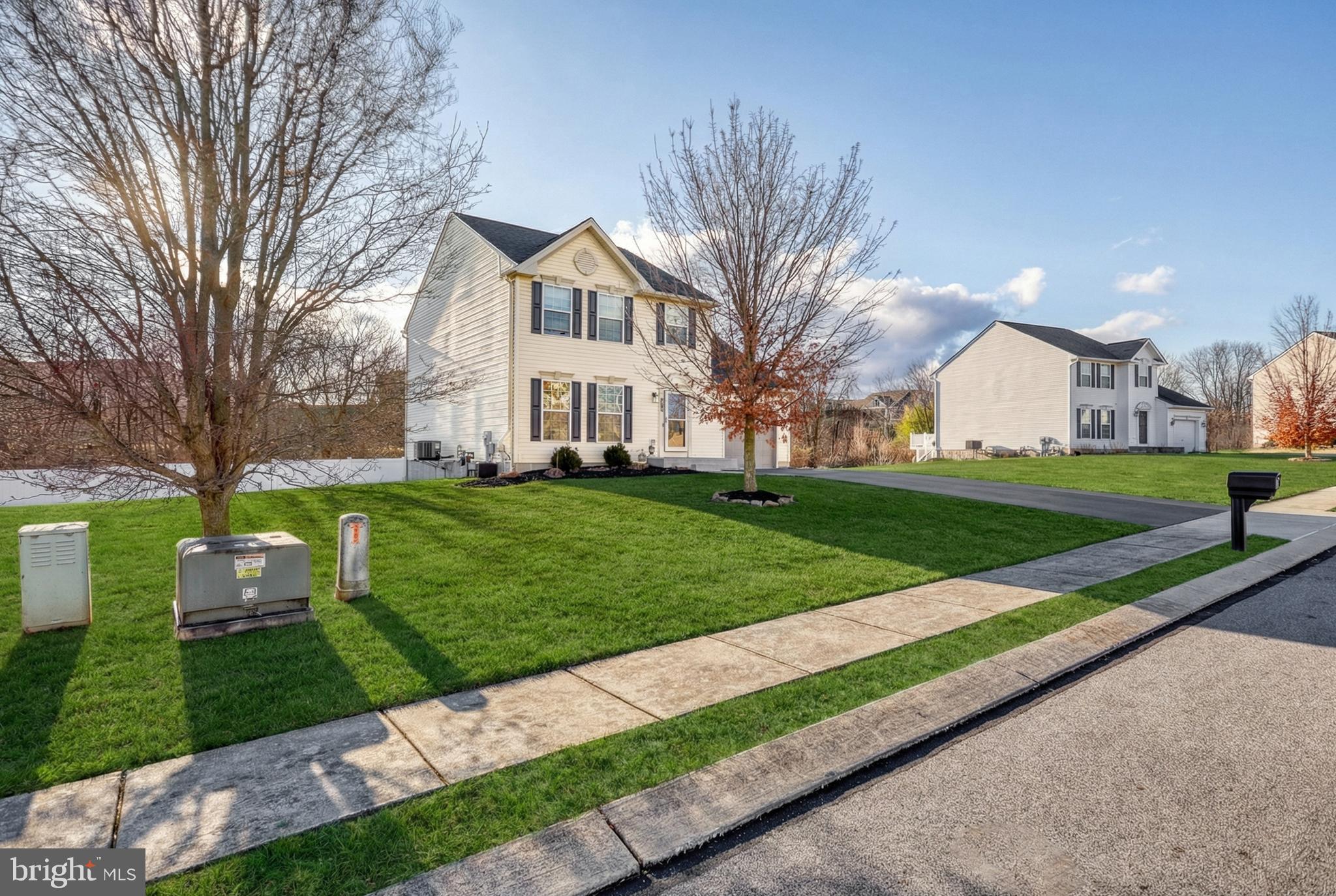 112 Farm Ln Circle York, PA 17408 - Photo 5 of 49 a front view of a house with a yard and trees