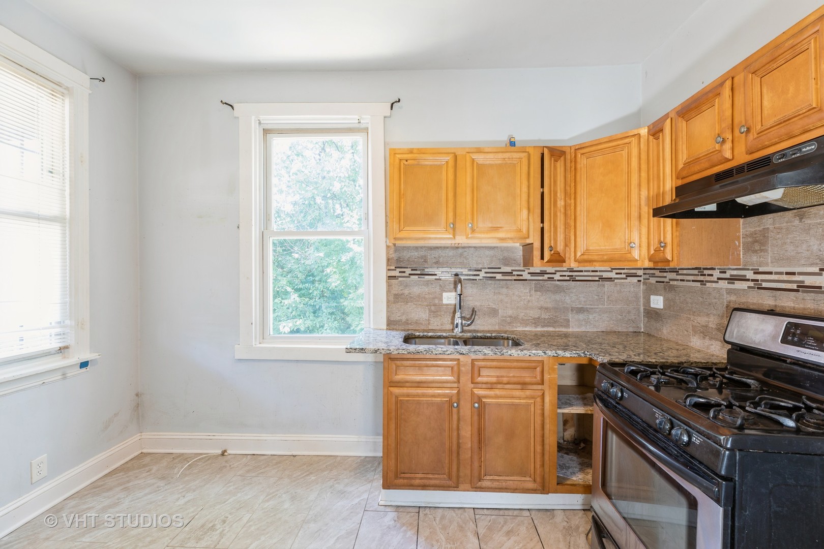 1024 West 87th Street Chicago, IL 60620 - Photo 4 of 10 a kitchen with a sink stove top oven and cabinets