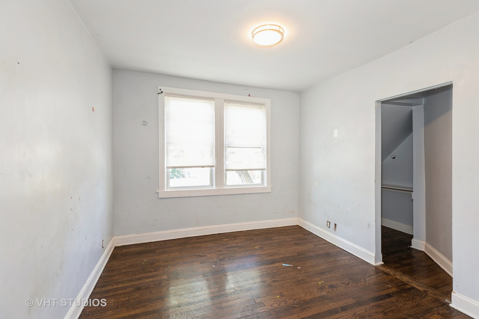 1024 West 87th Street Chicago, IL 60620 - Photo 5 of 10 an empty room with wooden floor and windows