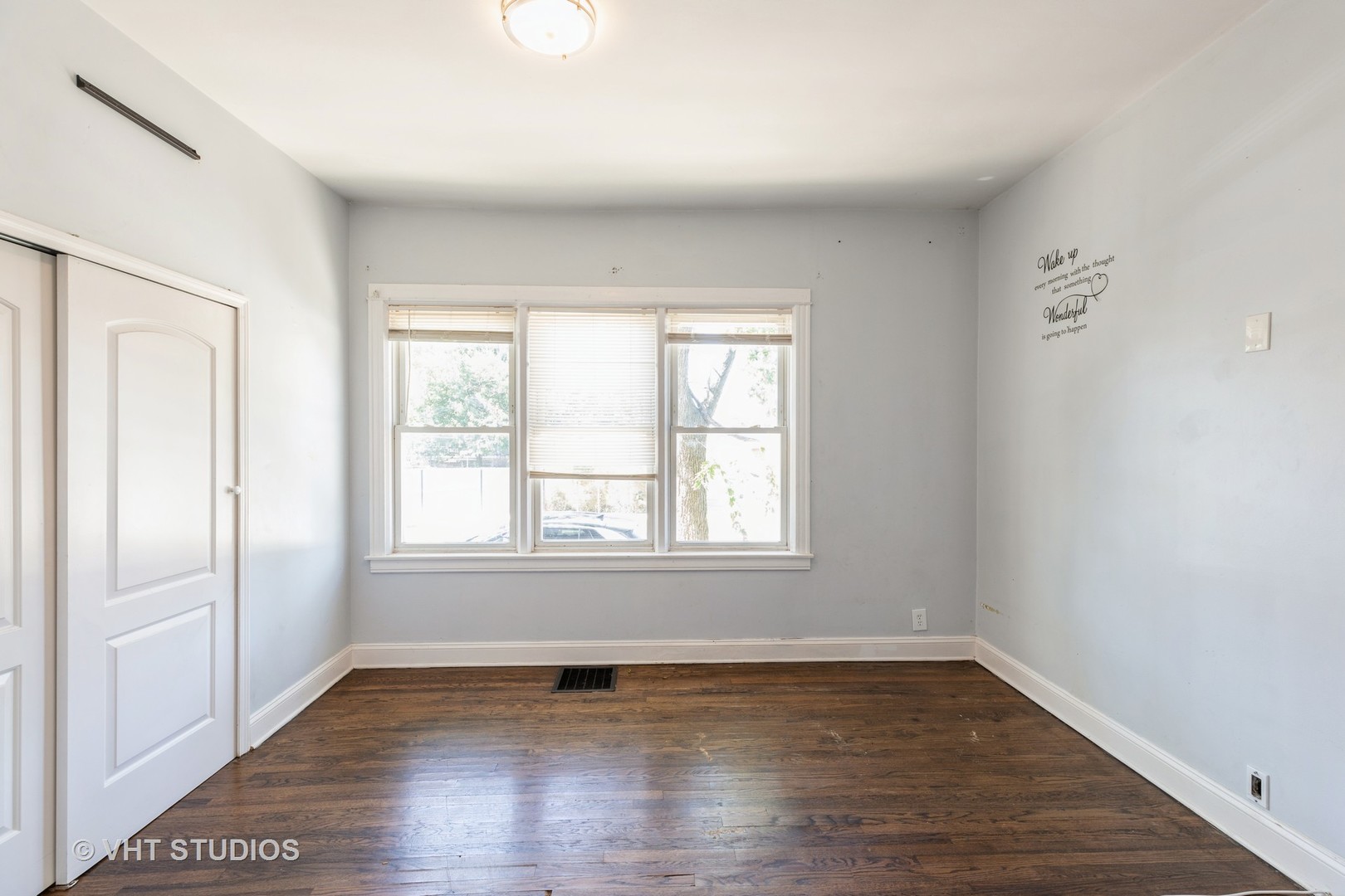 1024 West 87th Street Chicago, IL 60620 - Photo 6 of 10 an empty room with wooden floor and windows