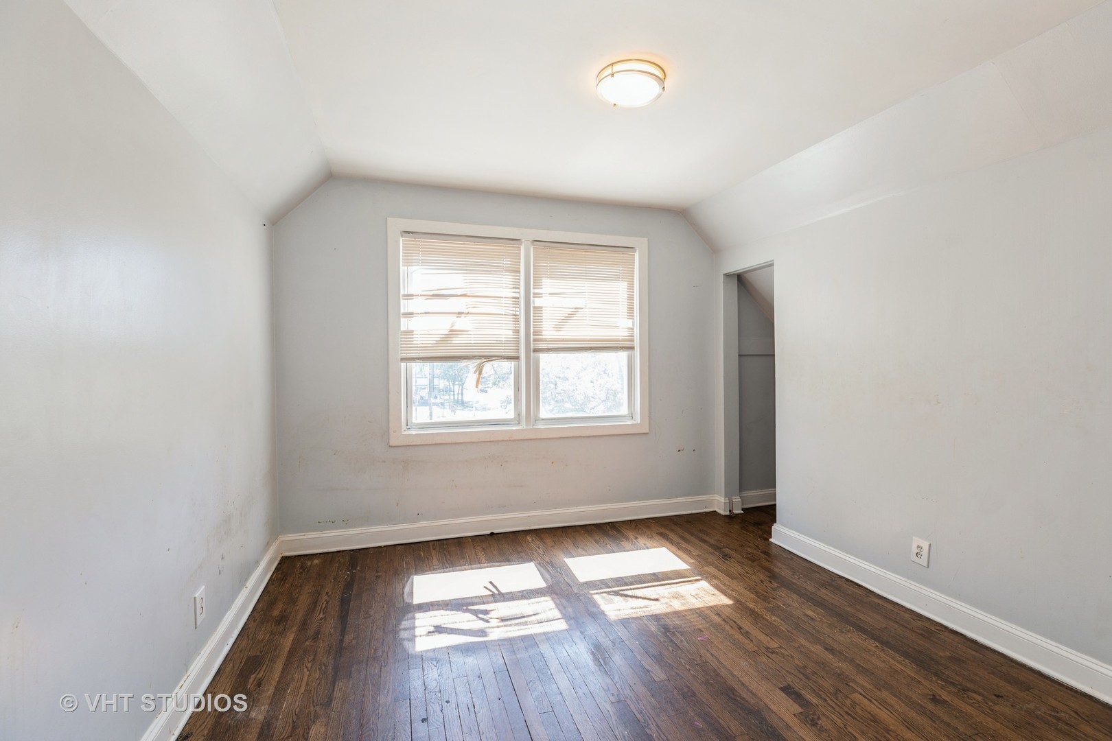 1024 West 87th Street Chicago, IL 60620 - Photo 7 of 10 an empty room with wooden floor and windows