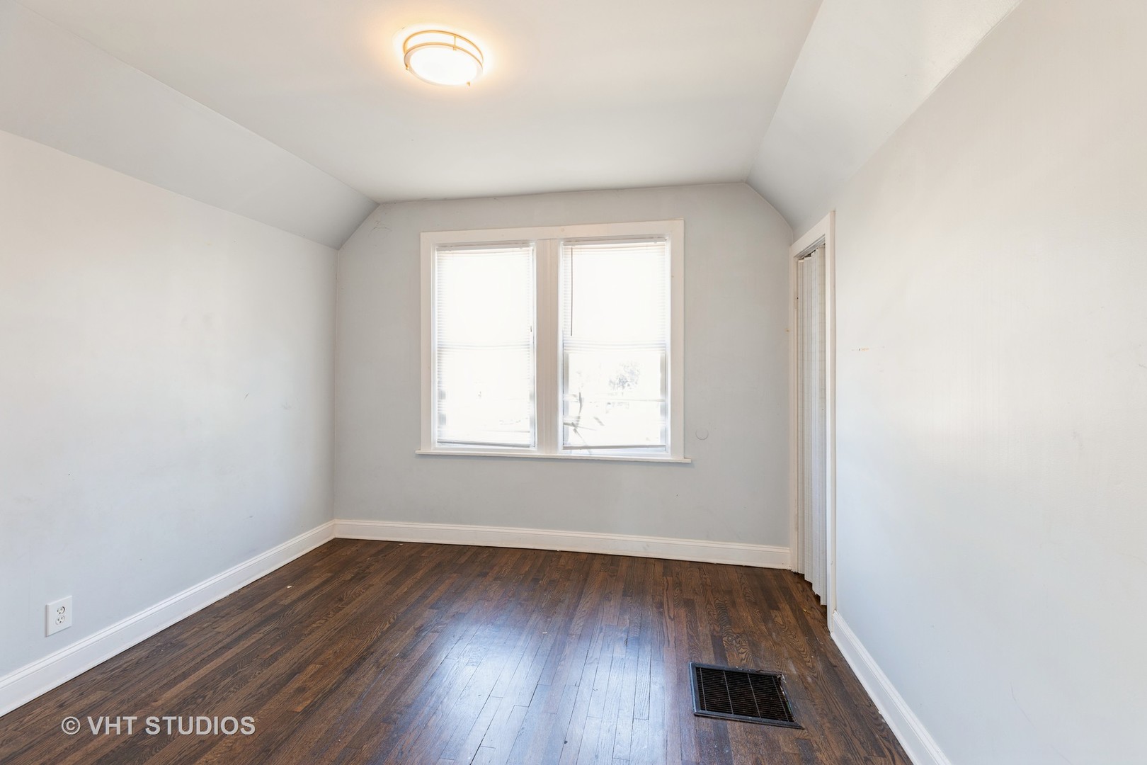1024 West 87th Street Chicago, IL 60620 - Photo 8 of 10 an empty room with wooden floor and windows