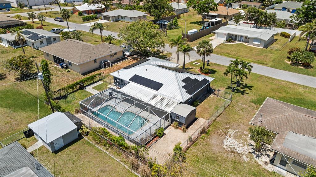 170 Argus Road Venice, FL 34293 - Photo 30 of 34 Spacious backyard with a sparkling in-ground pool, perfect for entertaining, relaxing, or enjoying Florida’s year-round sunshine. Fully fenced with plenty of room to garden, play, or host gatherings—your private outdoor oasis awaits.