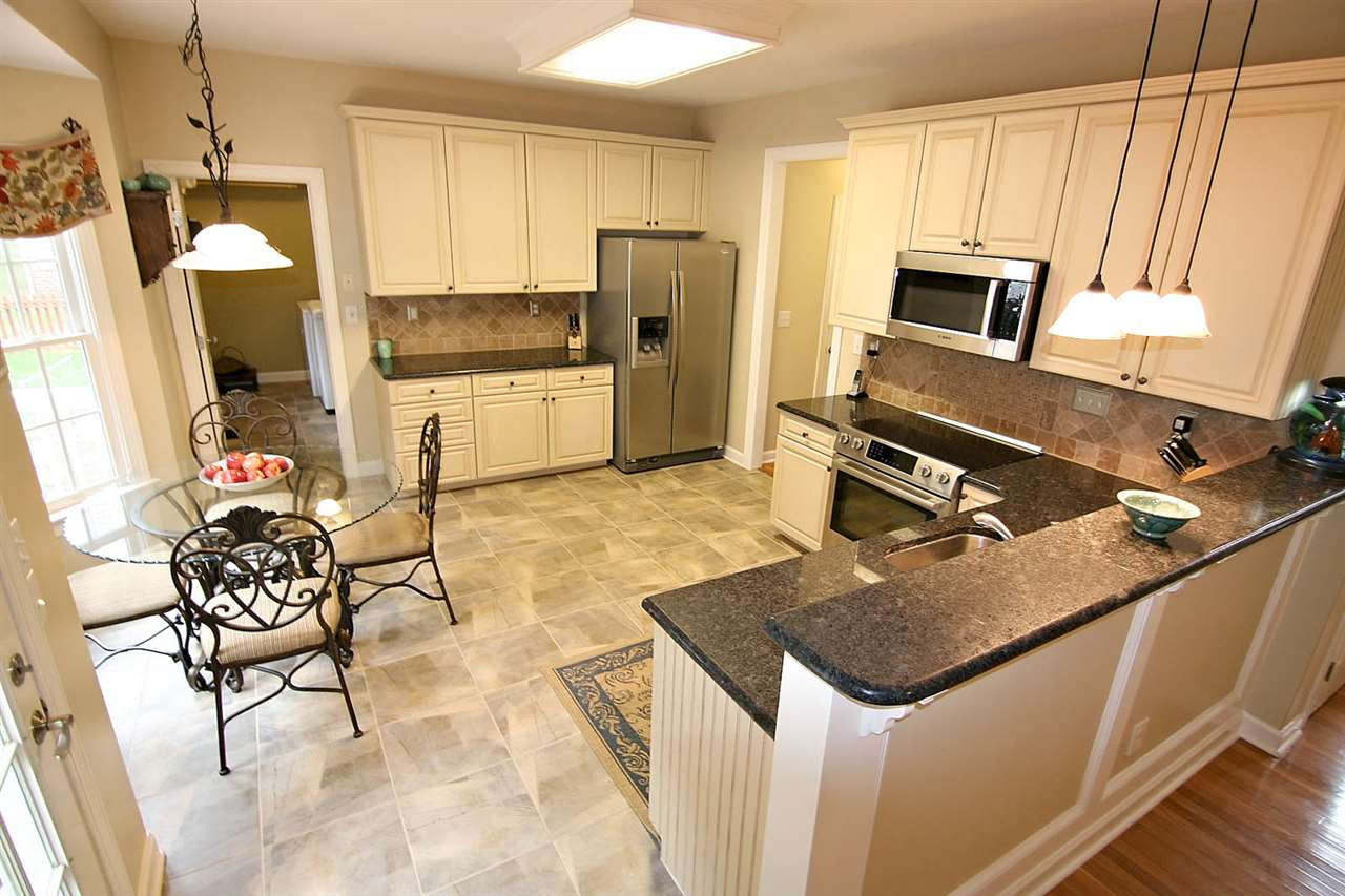 4109 Batiste Road Raleigh, NC 27613 - Photo 10 of 25 Kitchen with Granite Countertops and Tile Backsplash. Kitchen