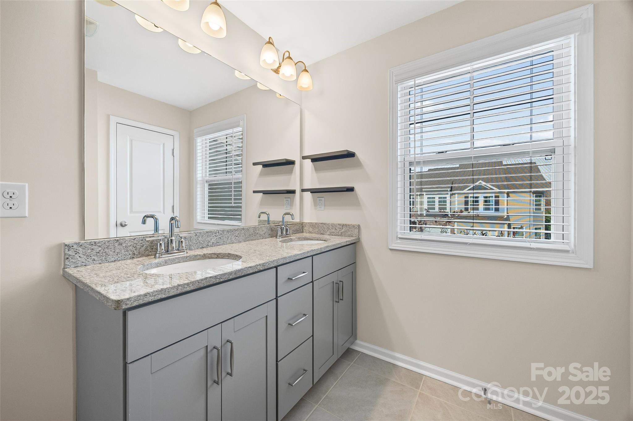 1018 Chicory Trace Clover, SC 29710 - Photo 16 of 37 a bathroom with a granite countertop sink and a window