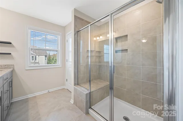 a bathroom with a glass shower door