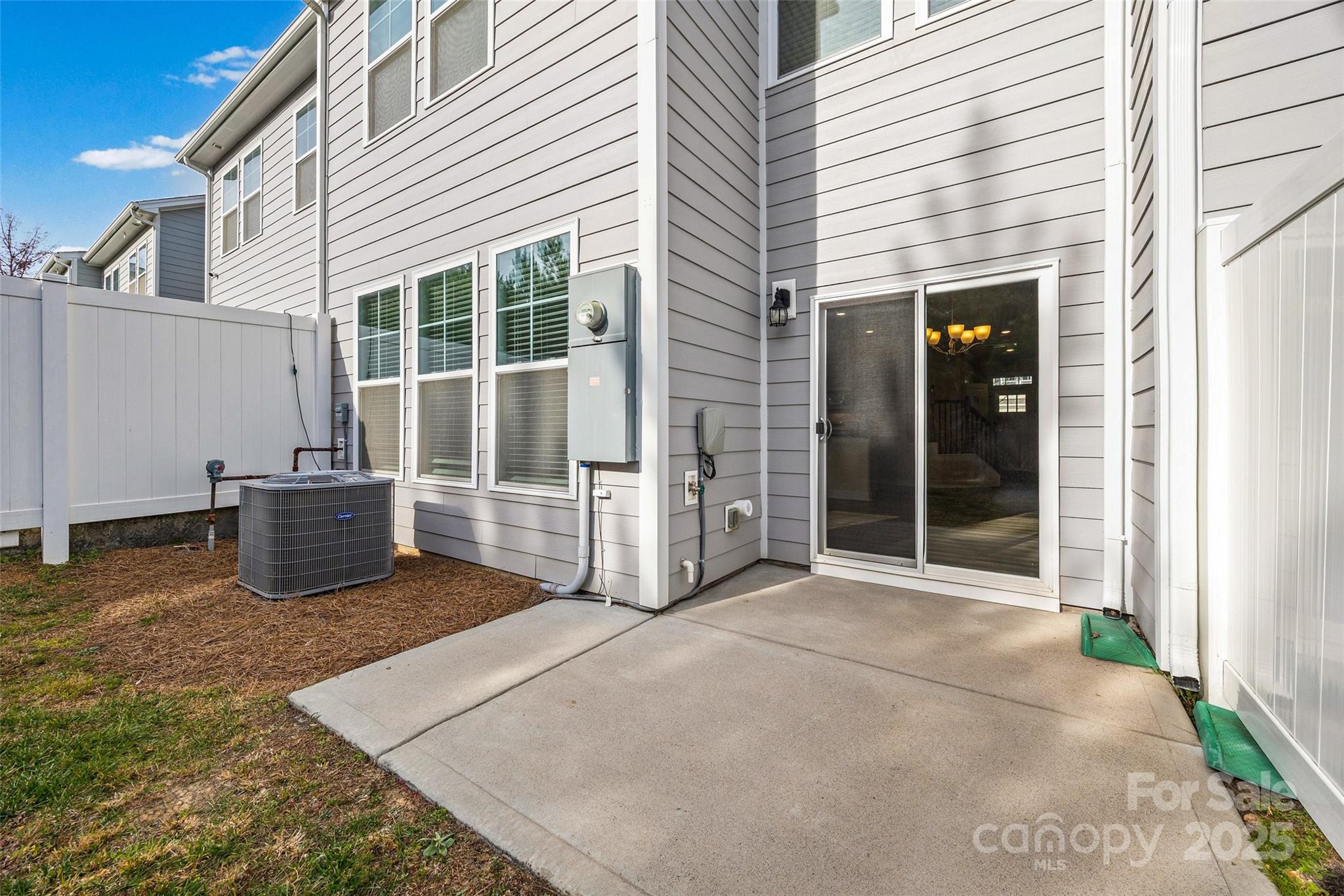 1018 Chicory Trace Clover, SC 29710 - Photo 25 of 37 a view of a house with a large window and wooden fence