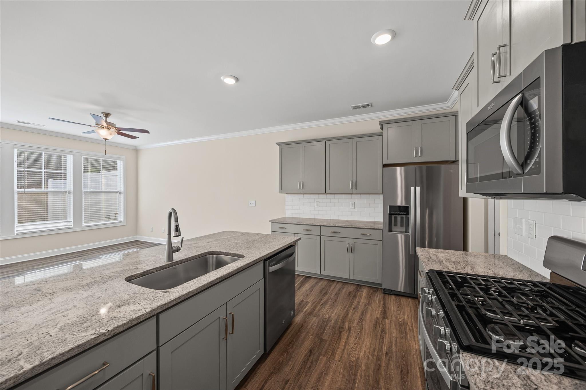 1018 Chicory Trace Clover, SC 29710 - Photo 5 of 37 a kitchen with stainless steel appliances granite countertop a sink stove and refrigerator