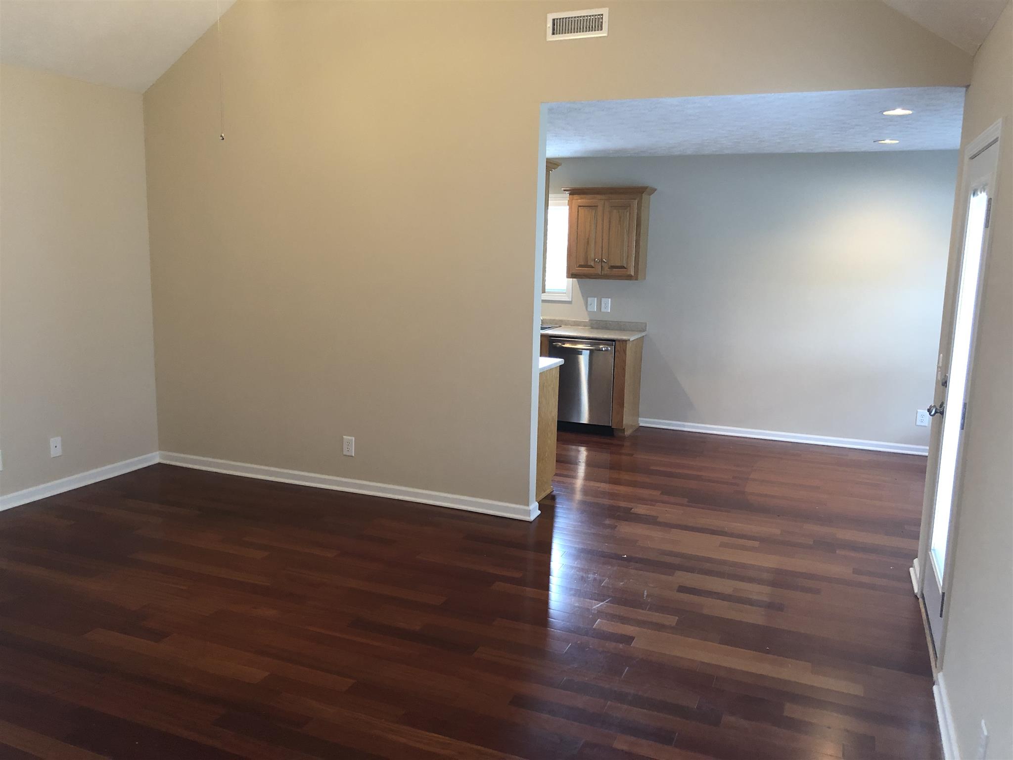 105 Foxrun Springfield, TN 37172 - Photo 10 of 21 a view of a room with wooden floor and a kitchen