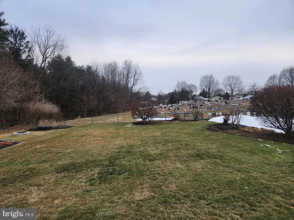 a kitchen with a refrigerator a stove a sink and a dining table
