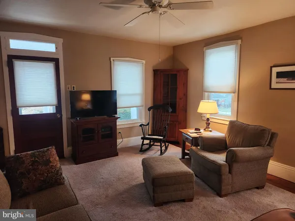 a living room with furniture and a lamp