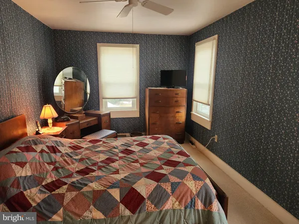 a bedroom with a bed and a mirror