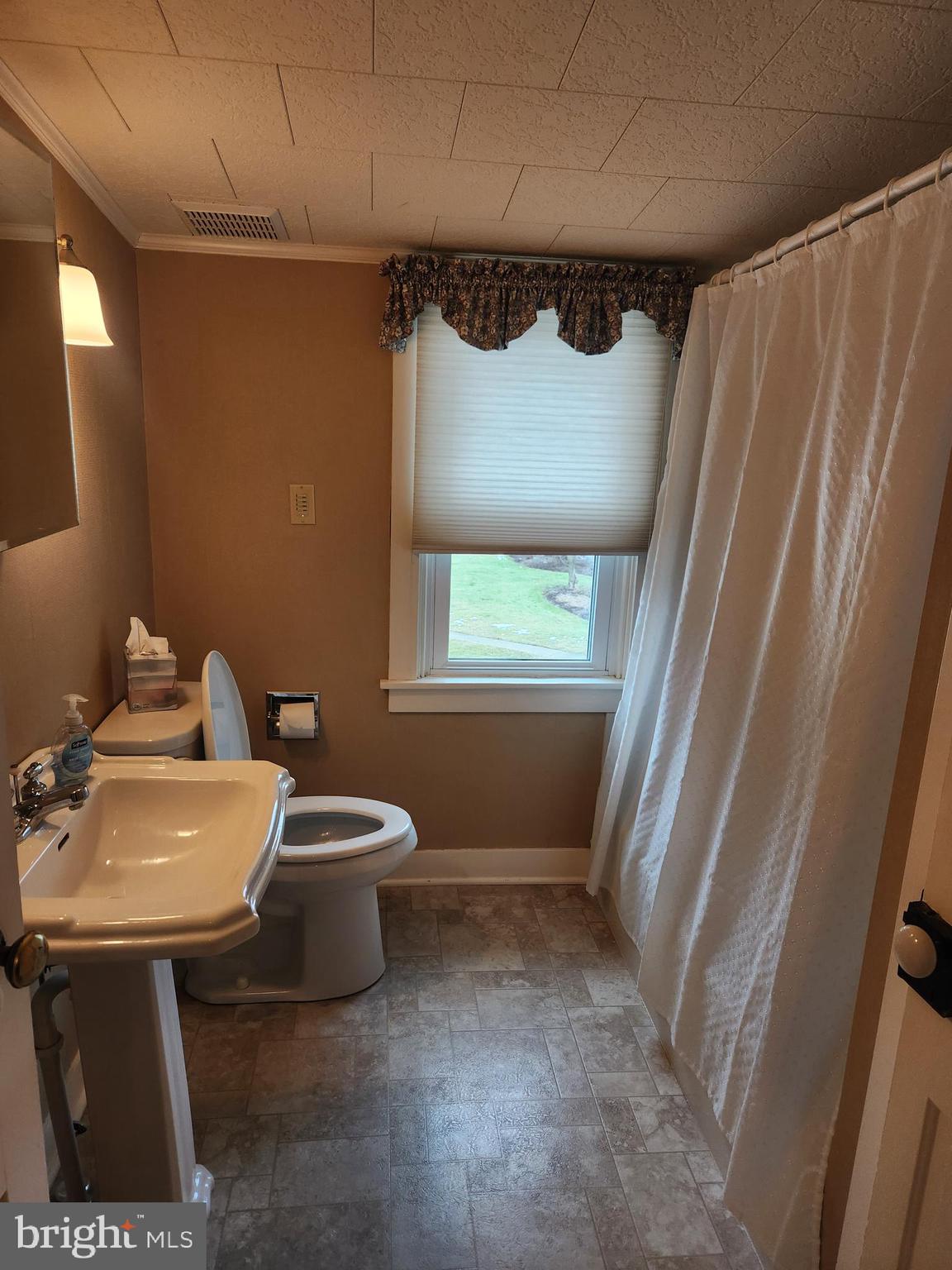 123 North 11th Street Akron, PA 17501 - Photo 27 of 43 a bathroom with a sink toilet and window