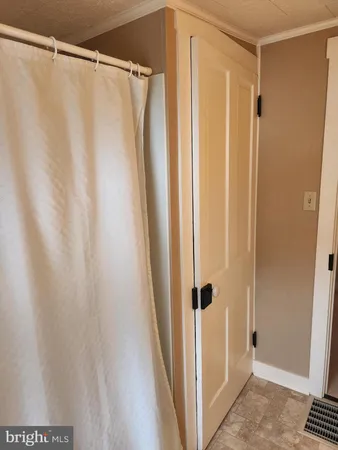 a bedroom with a bed and a mirror