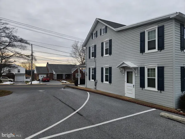 a view of a building with car parked