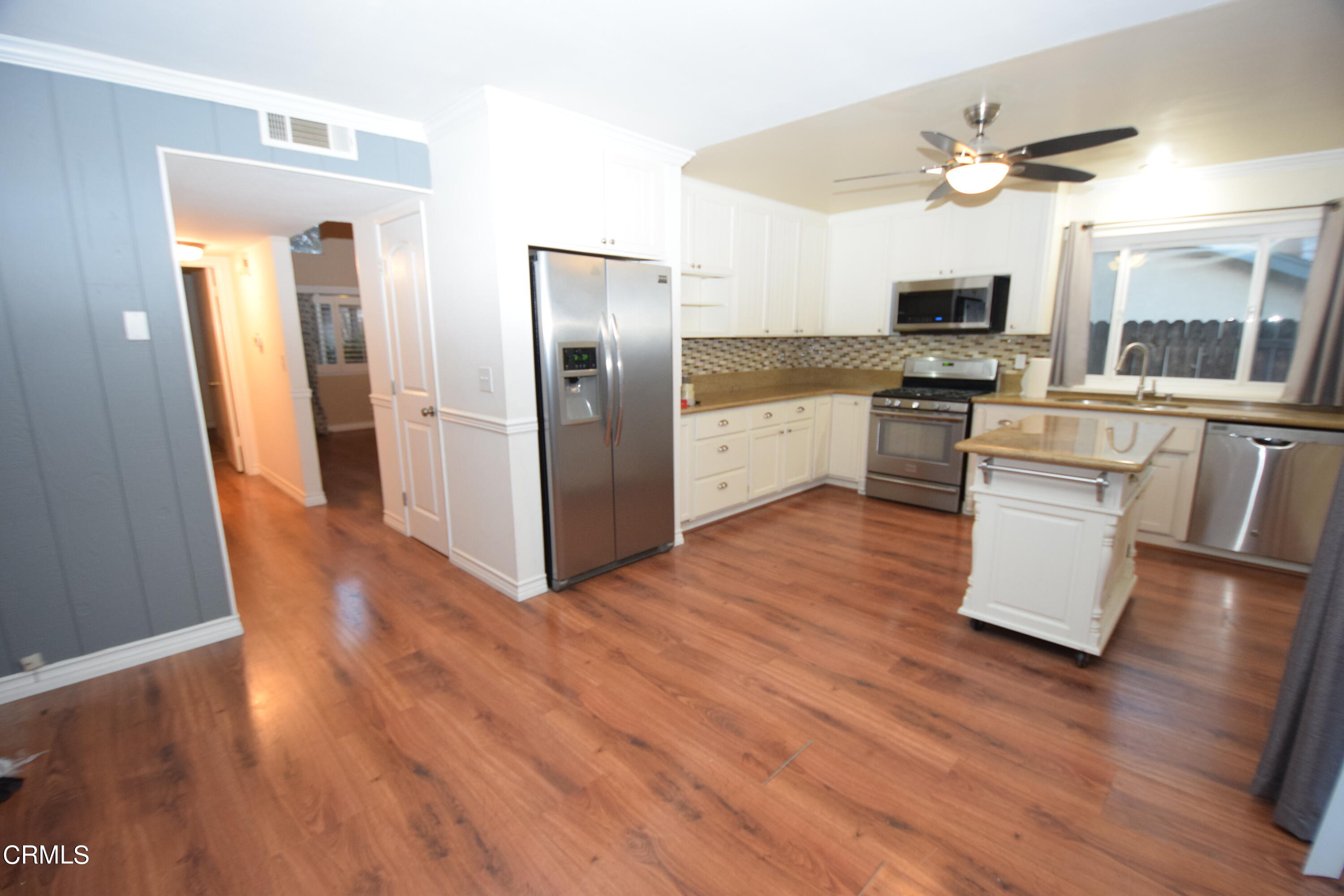 166 Ripley Street Camarillo, CA 93010 - Photo 11 of 28 a kitchen with granite countertop a refrigerator and microwave