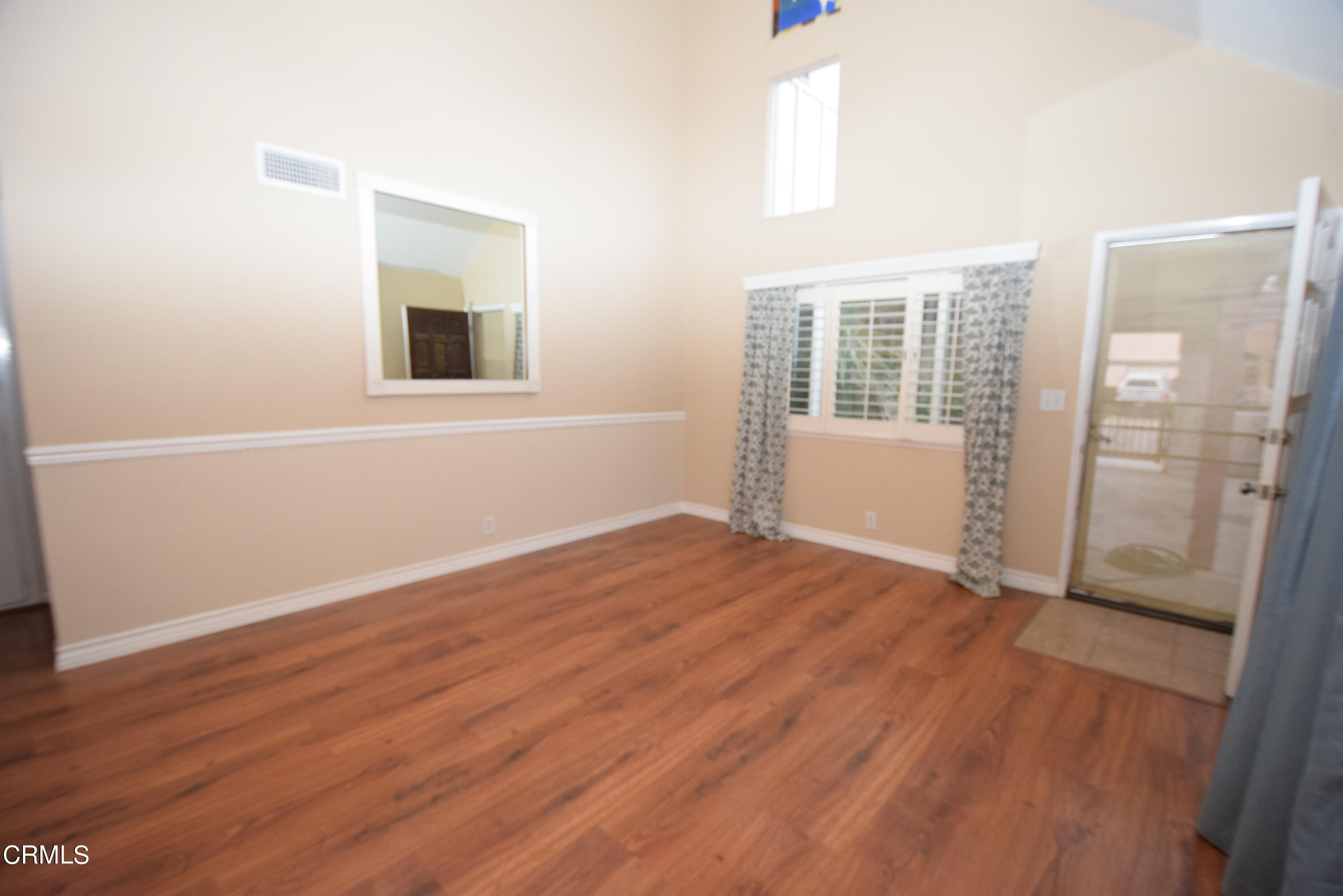166 Ripley Street Camarillo, CA 93010 - Photo 4 of 28 an empty room with wooden floor and windows