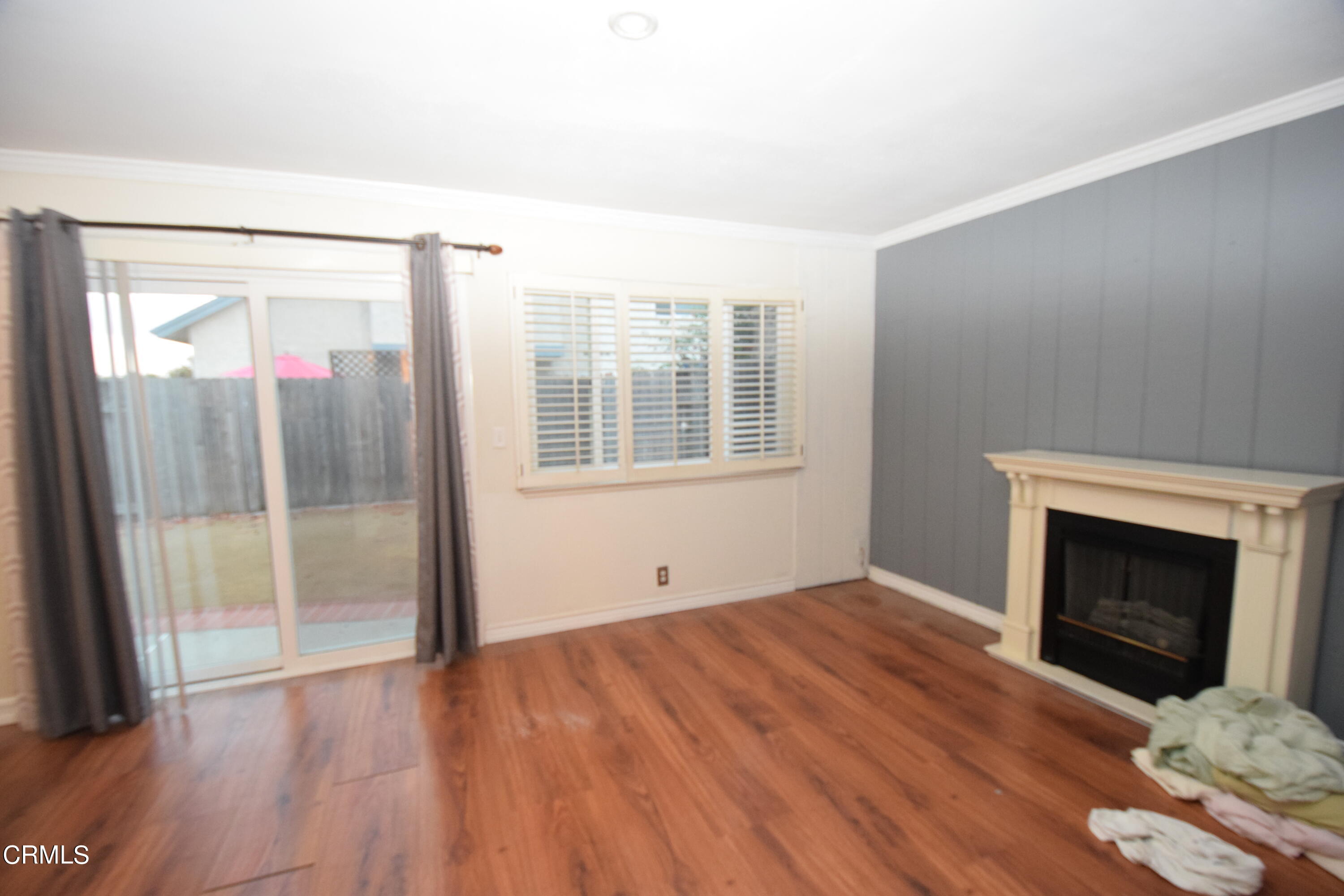 166 Ripley Street Camarillo, CA 93010 - Photo 9 of 28 a view of empty room with wooden floor and fireplace
