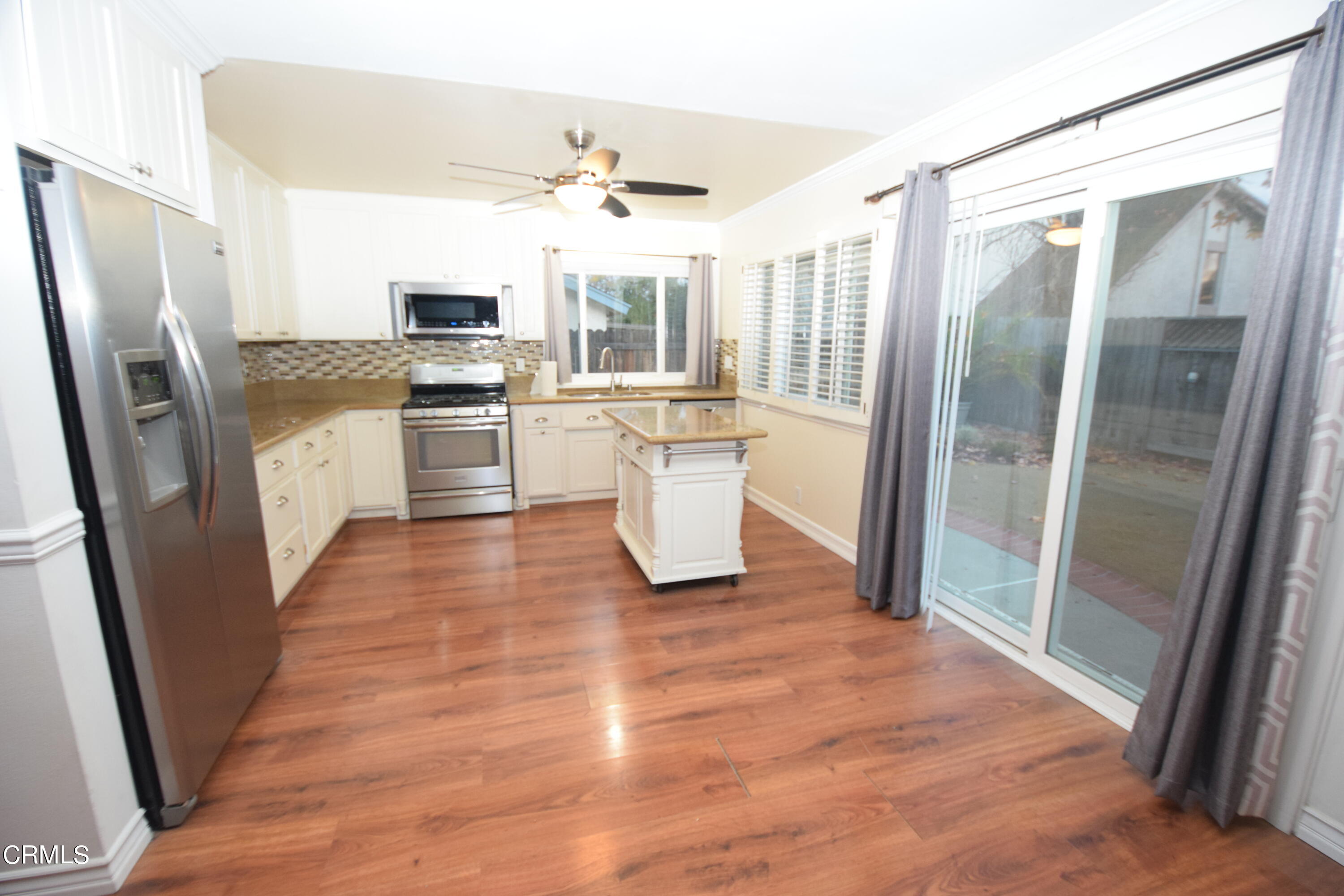 166 Ripley Street Camarillo, CA 93010 - Photo 10 of 28 a kitchen with a refrigerator a sink a stove a washer dryer and microwave