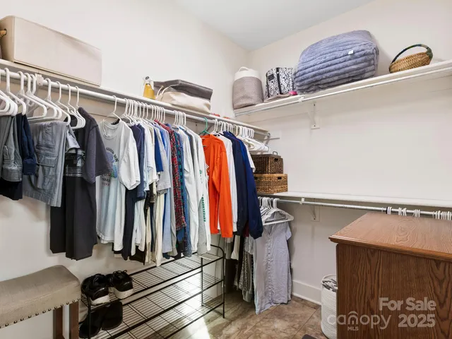 a view of hallway with cabinets and wooden floor