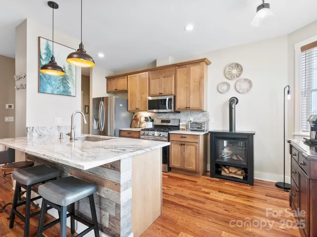 a living room with furniture fireplace and wooden floor