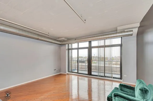 a room with a bed and wooden floor