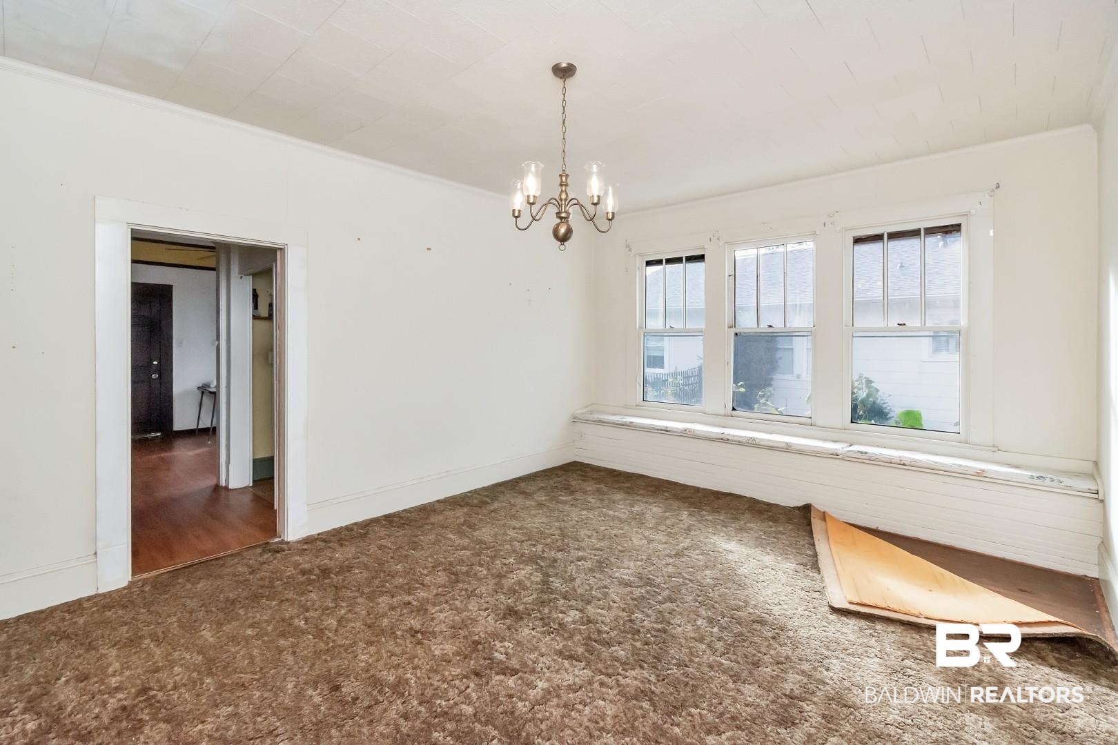 4305 Stein Street Mobile, AL 36608 - Photo 7 of 22 Carpeted empty room featuring a notable chandelier