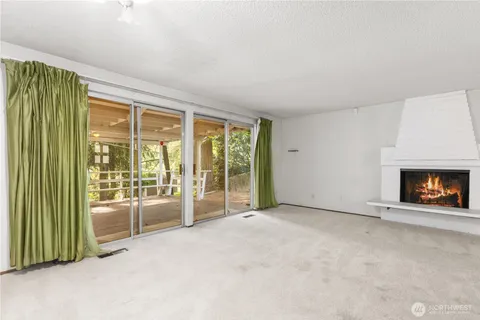 an empty room with furniture and a fireplace