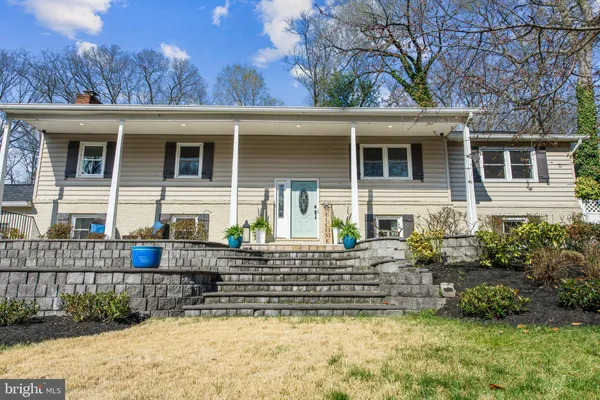 a kitchen with stainless steel appliances granite countertop a sink a stove top oven a counter space and cabinets